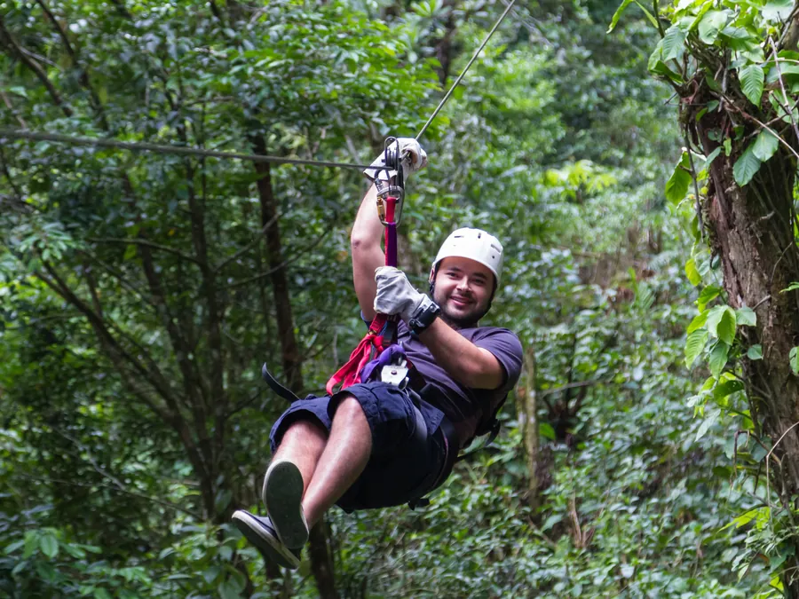 Rider ziplining through the forest canopy on a Cañon de la Vieja adventure from Playas del Coco