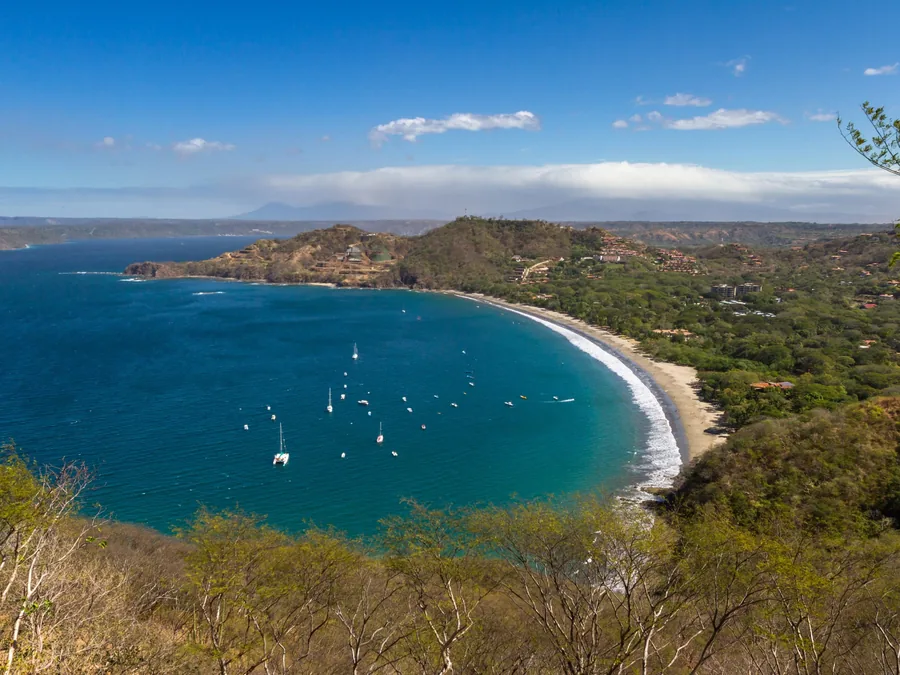 Hilltop view over a curved bay and dry forest on the Gulf of Papagayo, Guanacaste