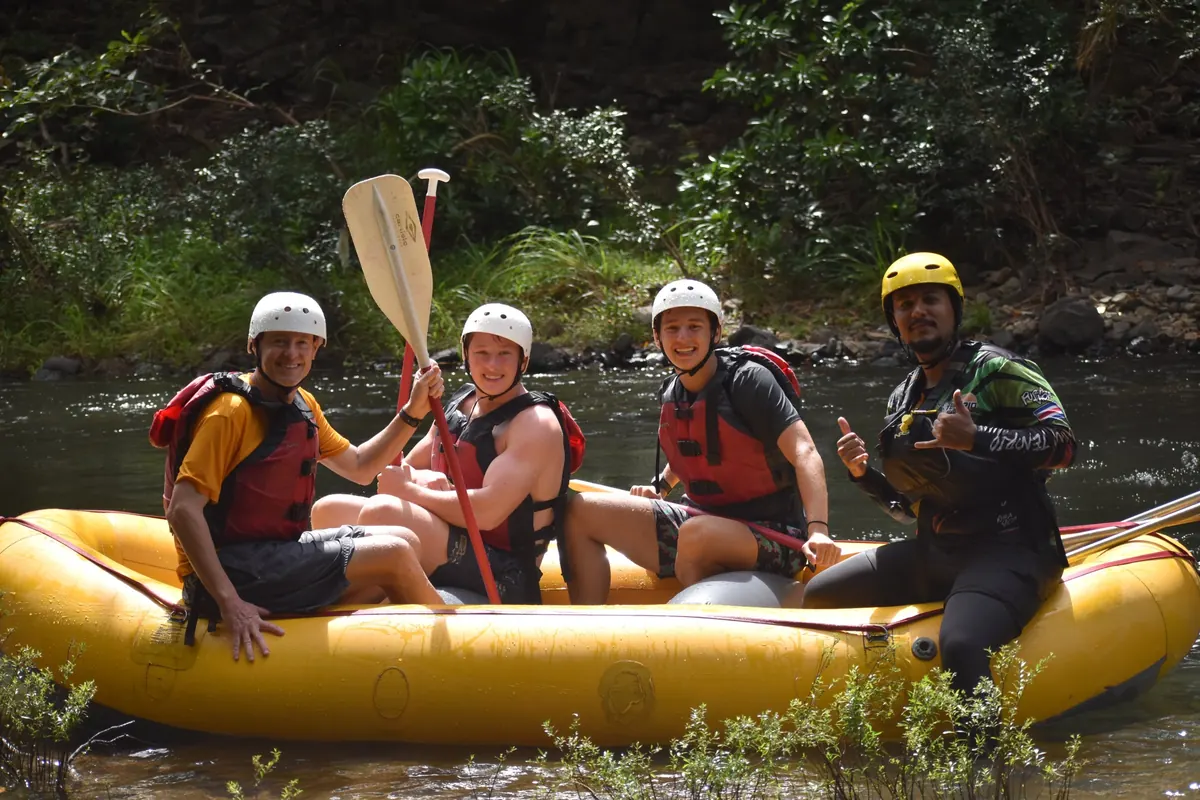 Group in helmets and life jackets sitting in a raft with their guide before running the Tenorio River